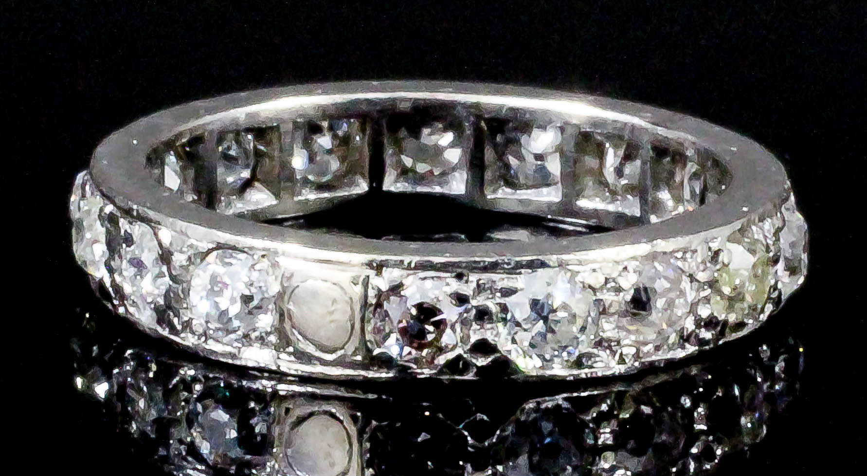 A modern silvery coloured metal all diamond set full hoop eternity ring, the face set with