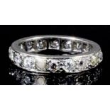 A modern silvery coloured metal all diamond set full hoop eternity ring, the face set with