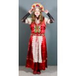 An early 20th Century Hungarian national costume comprising - floral headdress, waistcoat, skirt and