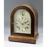 A late 19th Century mahogany cased mantel clock by Winterhalder & Hofmeier, the arched silvered dial