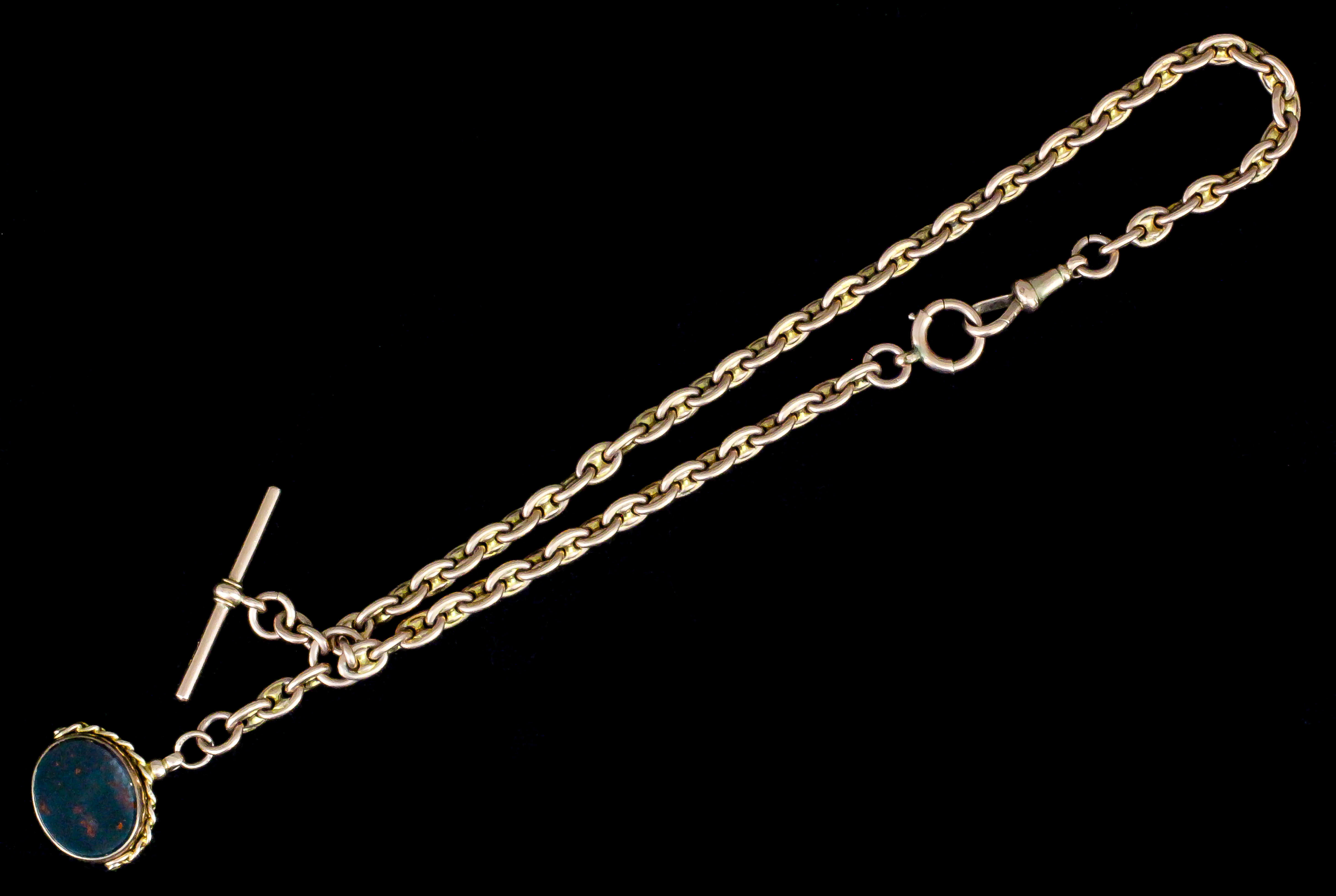 A 9ct rose gold Albert with heavy oval links (weight 35 grammes), and with 9ct gold mounted oval