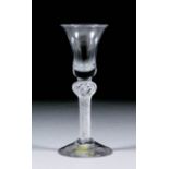 An 18th Century English cordial glass, the bell-shaped bowl over air twist stem with single knop, on