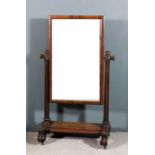 A Victorian mahogany framed rectangular cheval mirror inset with plain mirror plate, on turned