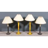 A pair of yellow lacquer electric table lamps with turned columns and circular bases, decorated in