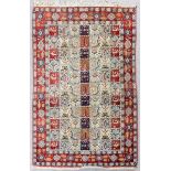 A Persian rug woven in colours, the central tiled design with seventy seven rectangular panels