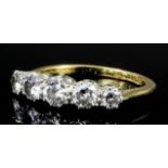 A modern 18ct gold mounted five stone diamond ring, the central brilliant cut stone of approximately