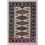 An Indian rug of "Persian" pattern woven in colours with five floral filled ovoid medallions,