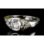 A modern 18ct white gold mounted diamond solitaire ring, the collet set rectangular stone of