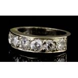 A modern 18ct white gold mounted diamond half hoop eternity ring, the face set with six brilliant