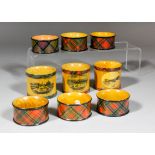 Two Victorian Mauchline Tartan ware napkin rings, one with a scene of beach and pier and Lowestoft