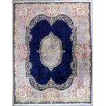 A Kirman carpet woven in colours in the "Aubusson" manner with a central medallion, with