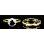 A modern 18ct gold and platinum mounted sapphire and diamond ring, the circular cut sapphire of