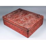 A Japanese cinnabar lacquer box, the lid carved with standing figures against an extensive watery