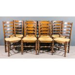 A set of eight oak ladder back dining chairs of "19th Century Lancashire" design, with rush seats,