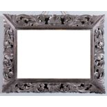 A late 19th Century carved oak framed rectangular wall mirror with bold leaf scroll carved frame and