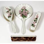 An Elizabeth II silver and cream guilloche enamel backed four piece dressing table set decorated