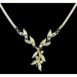 A modern 14ct gold and diamond set necklace, the flat chain link set to the centre with leaf pattern