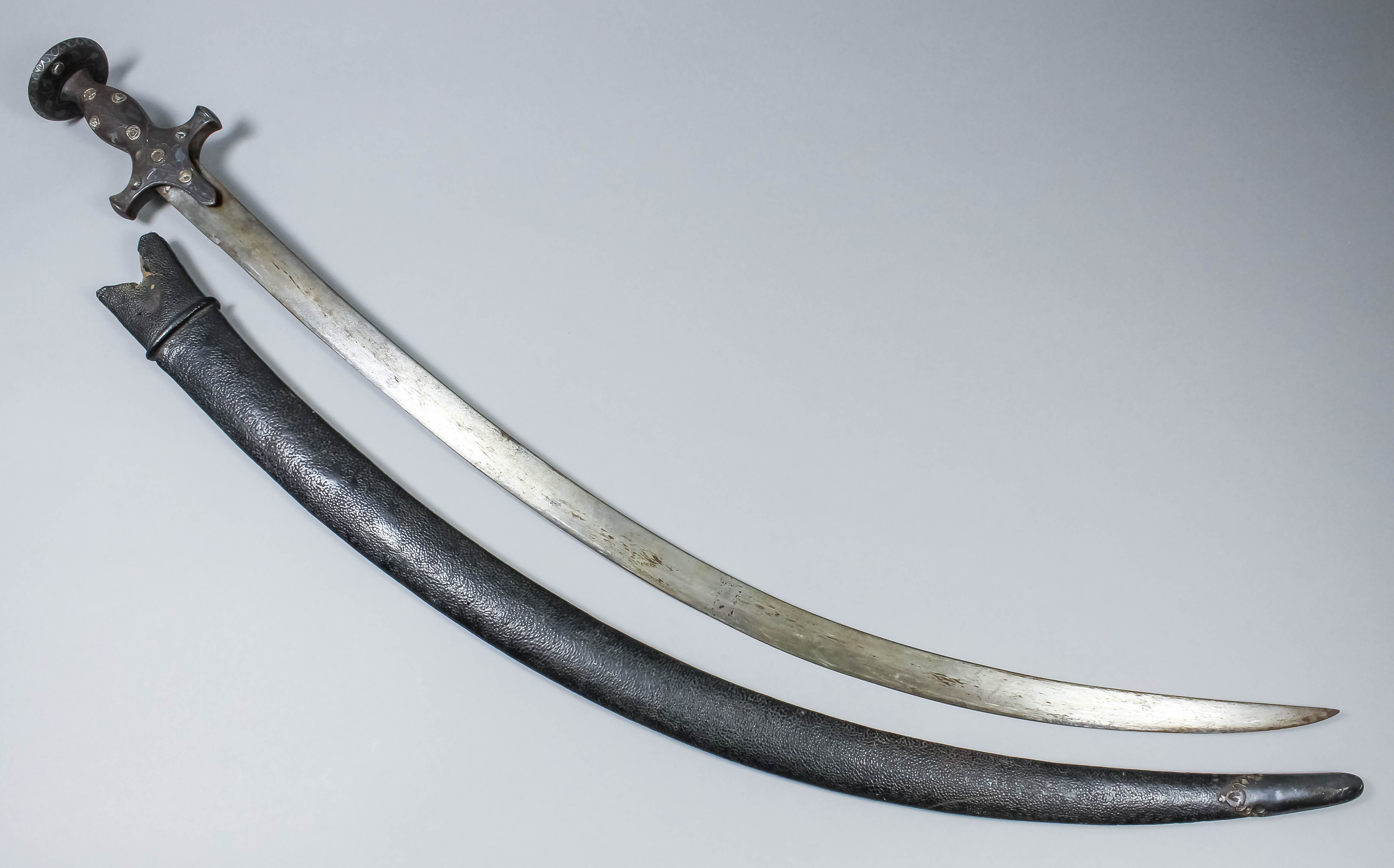 An 18th/19th Century Indian talwar, the 29.75ins steel blade with steel ...
