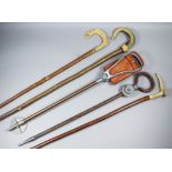 An early 20th Century "Modern" shooting stick, 32.5ins, another "Featherwate", and a collection of