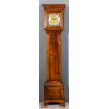 An 18th Century oak longcase clock, the 11ins square brass dial with wide silvered chapter ring with