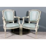 A pair of French grey and blue painted open arm fauteuils of "Louis XVI" design, with moulded