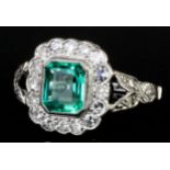 A modern 18ct white gold and platinum mounted emerald and diamond ring, the octagonal cut emerald of