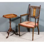 An Edwardian mahogany armchair with fretted oval rails to back, on slender turned uprights, the