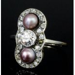 A late Victorian gold and silvery metal mounted pearl and diamond ring, the central old cut stone of