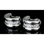 A pair of modern Chopard 18ct white gold mounted diamond set half hoop pattern earrings (for pierced