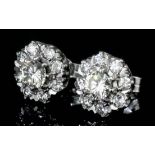 A pair of 18ct white gold mounted all diamond set flowerhead pattern earrings (for pierced ears)