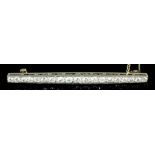 An Edwardian silvery coloured metal mounted all diamond set bar brooch, the face set with nineteen