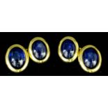 A pair of gentlemen's 18ct gold mounted sapphire set cufflinks, each face with an oval cabochon