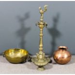 An Indian brass oil lamp with seven spouts and mythical bird pattern terminal, on octagonal turned