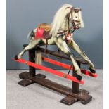 A small dappled grey painted wood rocking horse on red painted and stained wood stand, 36ins overall
