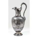 A Victorian silver urn pattern claret jug with moulded rim and high scroll handle with cast mask