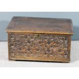 A late 17th Century oak bible box with moulded edge to top, the front carved with scroll ornament,