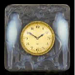 A 1920's René Lalique "Inseparables" opalescent desk clock moulded in relief with two pairs of