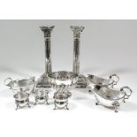 A pair of Elizabeth II silver pillar candlesticks with cast Corinthian capitals and stop fluted