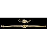 A modern 14ct gold triple flat link bracelet set to the centre with stylised leaves and six small