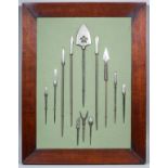 A mounted collection of twelve Japanese differing steel arrowheads (Yajiri) of various forms and