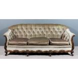 A Victorian walnut framed three seat settee with low back, upholstered in green dralon, the back and