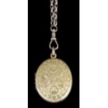 A late Victorian gold coloured metal oval locket, face with foliate engraving, the reverse