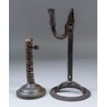 An early wrought iron candle and rush light holder, 11.25ins high, and a wrought iron adjustable