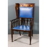 An Edwardian mahogany wing back easy chair of "Art Nouveau" design, with moulded cresting, the crest