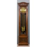 An early 20th Century Continental dark oak longcase clock, the 10.5ins diameter embossed brass