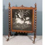 A Victorian walnut framed fire screen inset with embroidered panel depicting exotic birds amongst