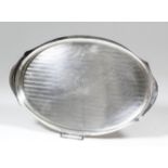 A George V silver oval two-handled tray with circular cartouche to centre and bands of reeded