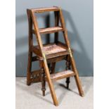 A Victorian oak metamorphic library chair/steps, the shaped crest rail with spindle turned supports,