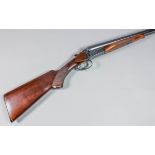 A 12 bore side by side shotgun by Baikal, Serial No. C5546, 29ins blued steel barrels with engine