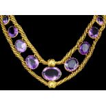 A late Victorian gold coloured metal mounted amethyst set necklace, the twin rope twist pattern
